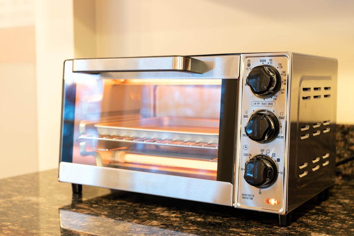 Stainless steel modern design toaster oven is on the granite kitchen countertop