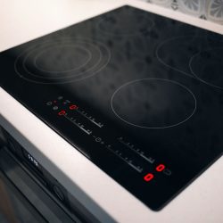 New electric stove with induction cooktop in kitchen, closeup