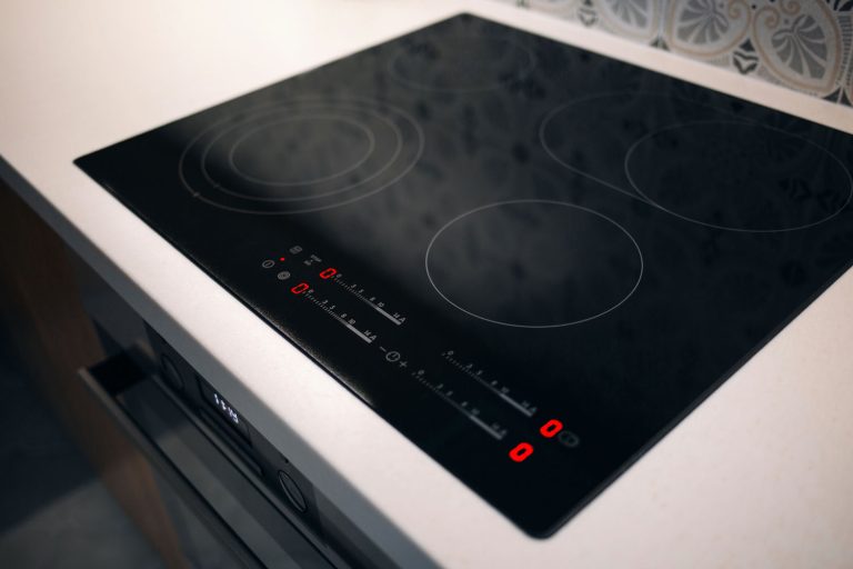 New electric stove with induction cooktop in kitchen, closeup
