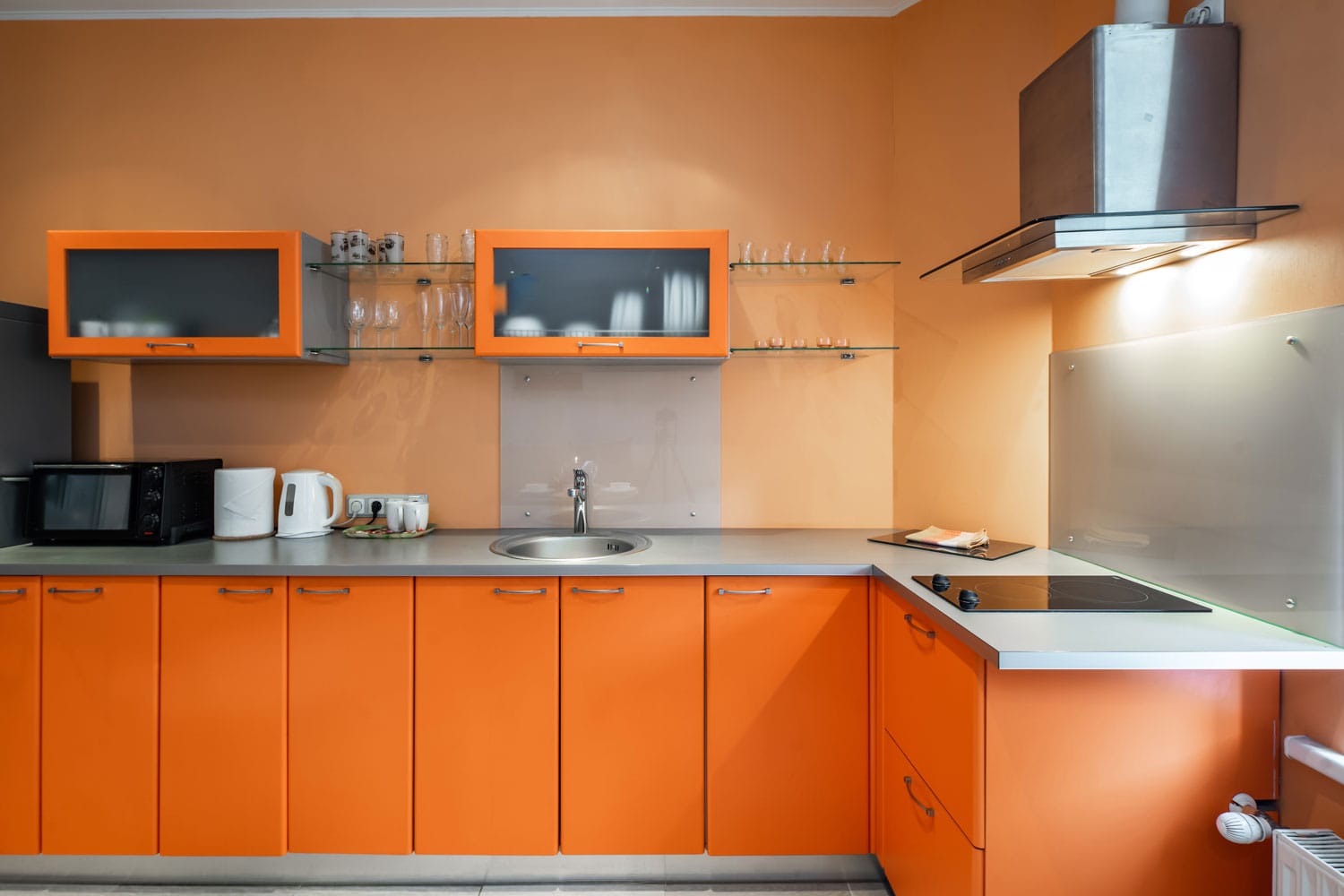 A gorgeous orange kitchen with matching orange walls