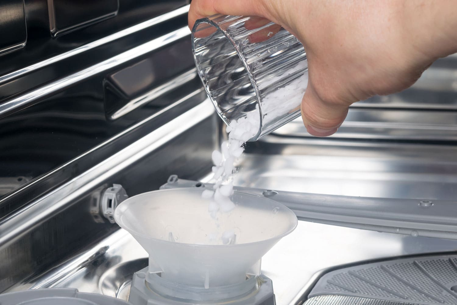 Adding dishwasher salt to the dishwasher
