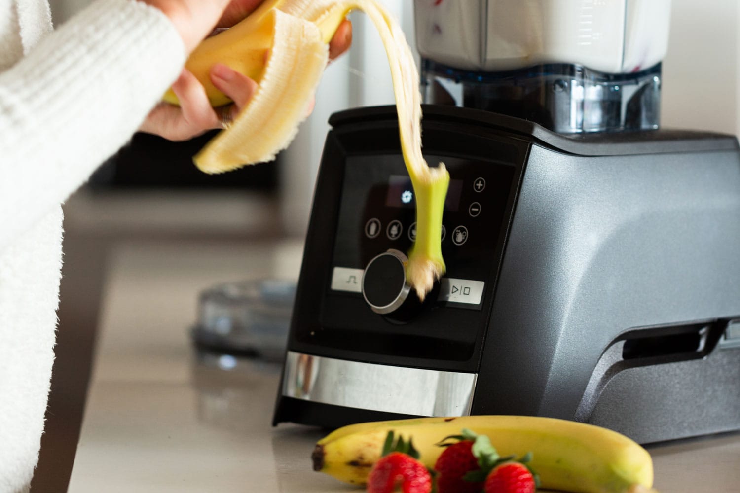 Making smoothie in the kitchen using a Vitamix blender