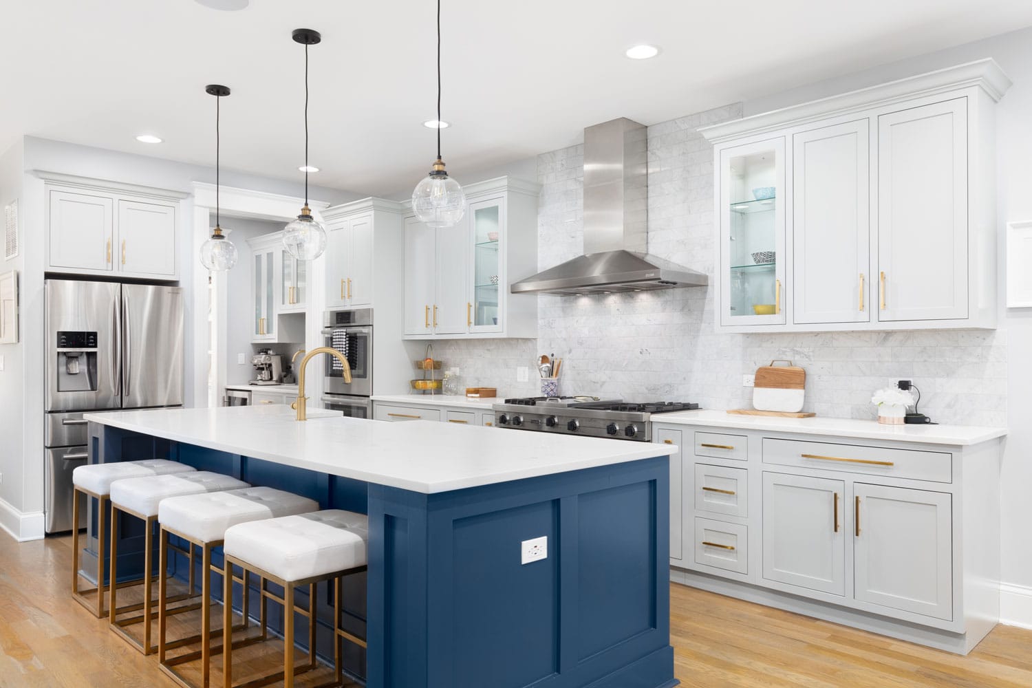 Ultra-modern kitchen with blue kitchen island with matching white granite countertop