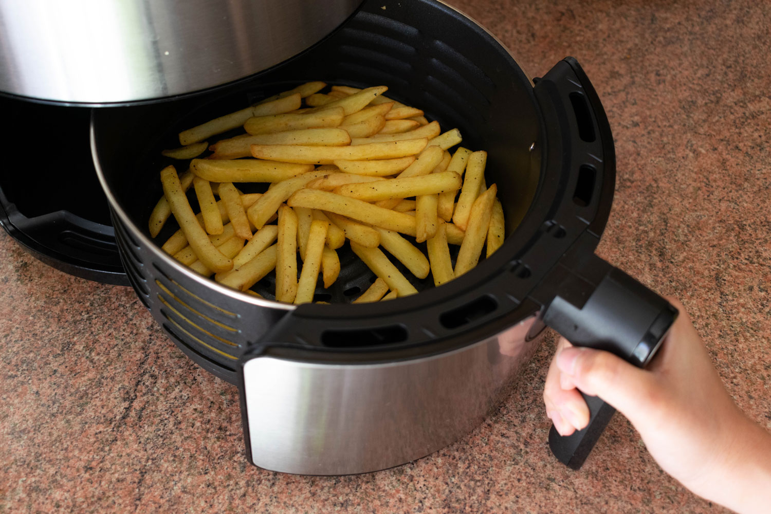 Putting french fries in the air fryer