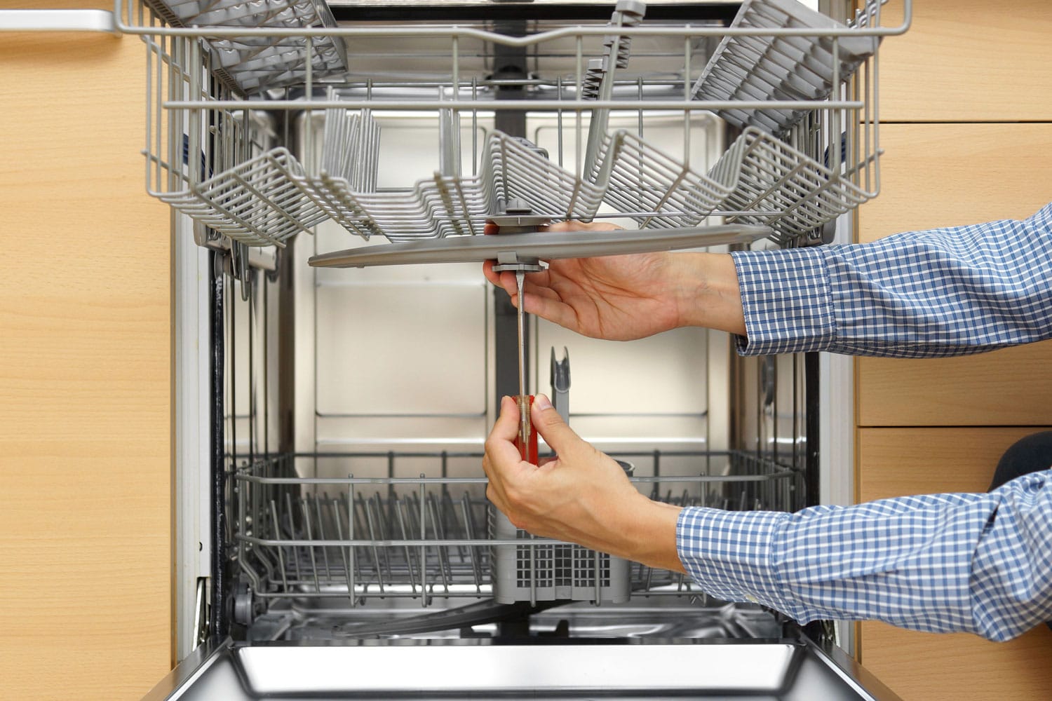 Worker installing a new dishwasher