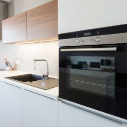 An oven placed in a modern kitchen, Do You Have To Crack The Oven Door When You Broil? Find Out Here! - 1600x900