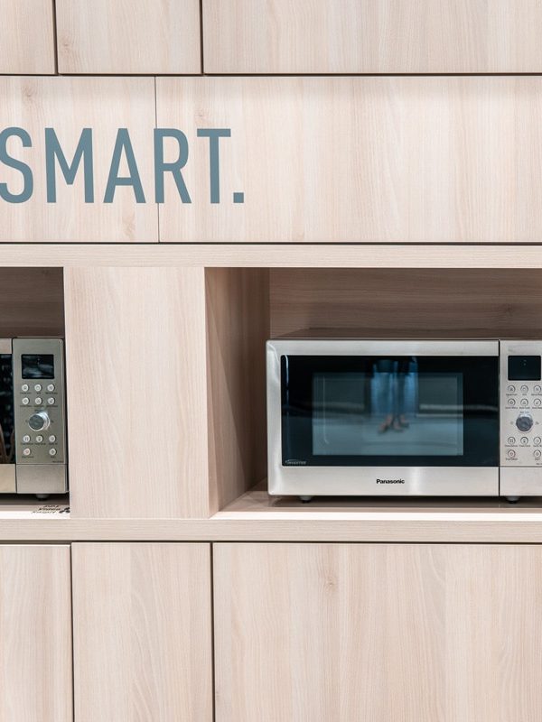 two microwaves displayed a panasonic brand
